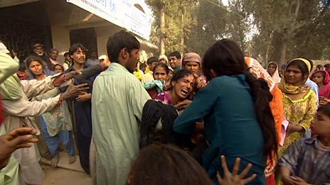 IDPs fight for blankets at a camp