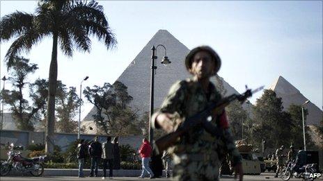 Egyptian army soldiers take position in front of the Giza pyramids