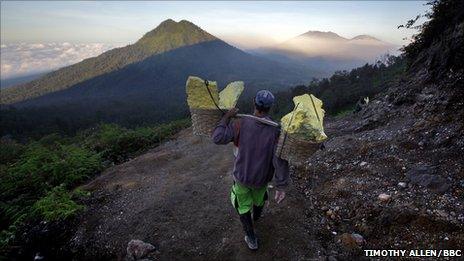 The workers carry loads of up to 90kg of sulphur mined from the volcano