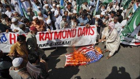 Supporters of the religious and political party Jamaat-e-Islami burn the US flag during a protest rally against American Raymond Davis in Karachi, 11 February 2011