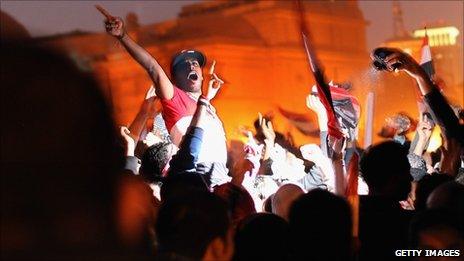Anti-government demonstrators celebrate in Tahrir Square upon hearing the news of the resignation of Egyptian President Hosni Mubarak on February 11, 2011 in Cairo, Egypt