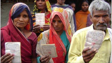 Residents of Pachdeora village show their BPL cards