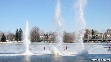 Plumes of water shoot into the air from the explosives