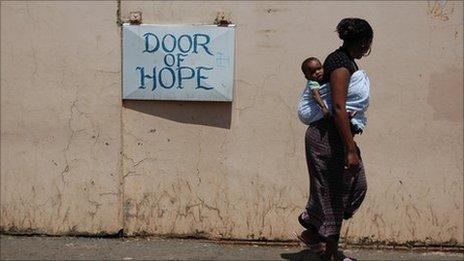 A mother walks past the Door of Hope orphanage in Berea, central Johannesburg