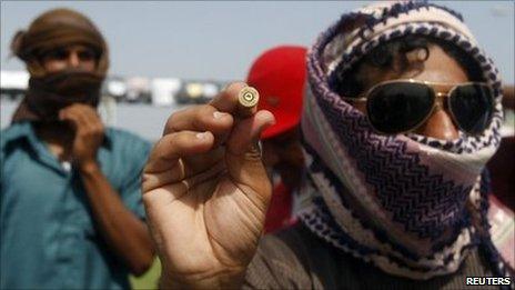 A protester holds up a spent bullet casing, which he says is from anti-riot police firing their weapons into the air in Sohar. Photo: 1 March 2011