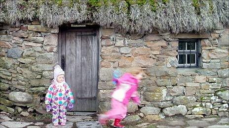 Children playing at the Leanach Cottage on Culloden battlefield