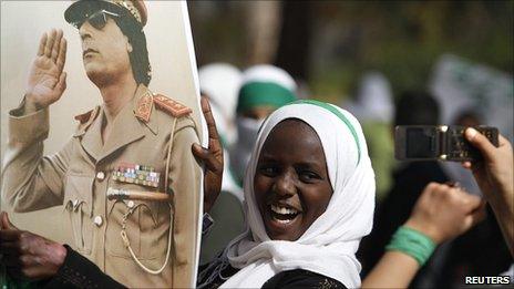 A schoolgirl shows her loyalty to Col Gaddafi during a demonstration outside a hotel where foreign media are staying in Tripoli on Monday