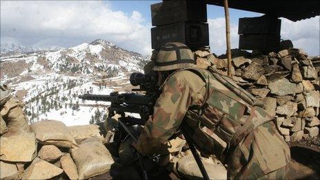 In this picture taken on Monday, March 7, 2011, a Pakistan army soldier takes position in the Pakistani tribal area of Datta Khel in North Waziristan where the Pakistan army are fighting against militants and al-Qaida activists along the Afghanistan border.