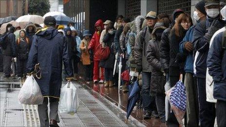 People queuing outside a shop in Japan