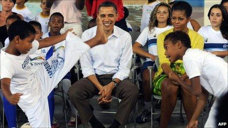 Barack Obama and wife Michelle attend a capoeira show in the City of God favela