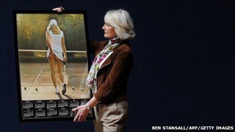 Fiona Walker holding a picture of 18-year-old self used in the Athena posters