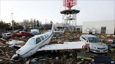 A light aircraft sits amongst the debris from the 11 March tsunami at Sendai Airport near Sendai, Miyagi prefecture