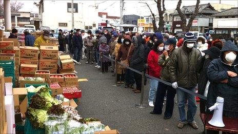 People still living in the area are forced to queue for rations. Pic: Dai Saito