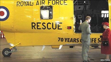 Prince William shows The Queen one of the SeaKing rescue helicopters