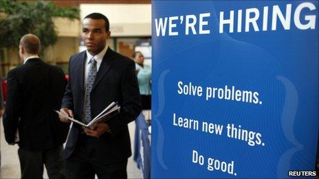 A job seeker walks the floor at a large career fare at Rutgers University in New Brunswick, New Jersey