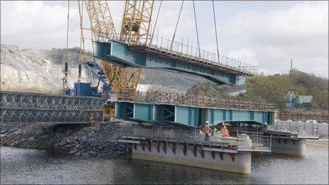 The bridge being lifted into place