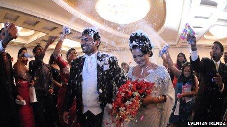 Wedding couple showered with confetti