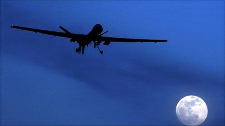 A US RQ-1 Predator drone or UAV (Unmanned aerial vehicle) flies over the moon above Kandahar Air Field, southern Afghanistan Sunday, Jan. 31, 2010.