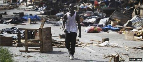 A man walks through a ransacked market in Abidjan April 14, 2011