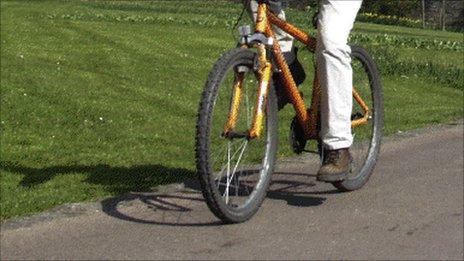 man cycling along path