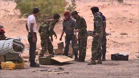 Libyan rebels unpack land-mines before laying them near Ajdabiya, 17 April