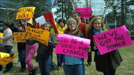 Canadian students holding political signs