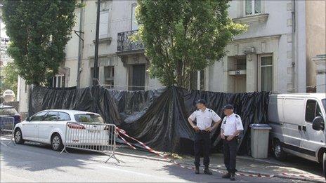 Police stand outside the house in Nantes where the family were living, 21 April