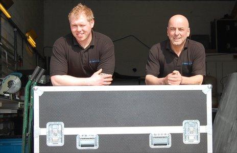 Daniel Henderson (left) and Gary Irons lean against one of their newly manufactured flight cases