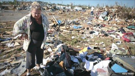 A resident of Tuscaloosa looking at the remains of her home