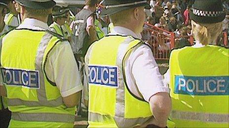 Police officers watching a crowd