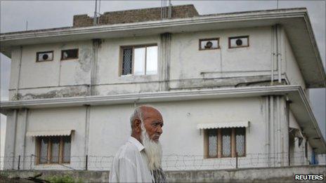 A resident walks past the compound where US commandoes killed Bin Laden. Photo: 5 May 2011