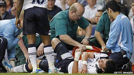 Tottenham winger Gareth Bale receives treatment before being substituted against Blackpool after a tackle by Charlie Adam