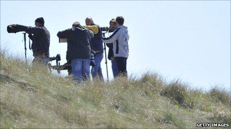 Photographers near the perimeter of RAF Valley in Anglesey, north Wales May 3, 2011