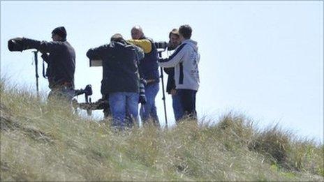 Photographers near the perimeter of RAF Valley in Anglesey, north Wales May 3, 2011