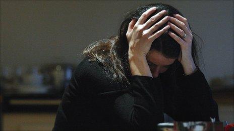 Woman holding her head in her hands