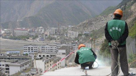 Construction workers build a viewing platform above a quake-hit town in Sichuan on 19 April 2011