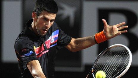 Novak Djokovic plays a shot against Andy Murray