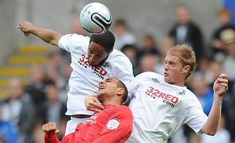 Ashley Williams wins an aerial battle against Nottingham Forest