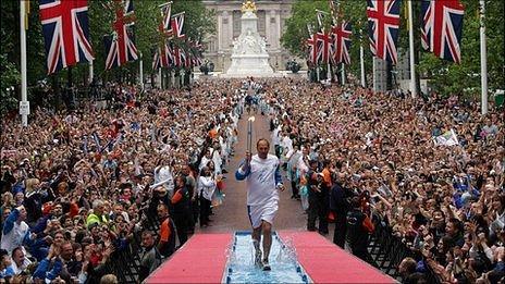 Olympic flame being carried by Steve Redgrave