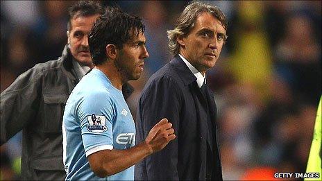 Carlos Tevez (left) and Roberto Mancini