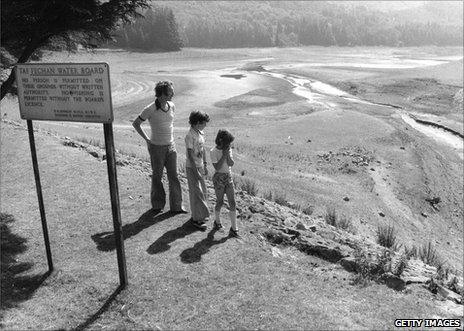 Local residents survey the Taf Fechan reservoir in South Wales, nearly dry because of drought, 12 August 1976