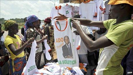 A vendor sells T-shirts bearing the portrait of Ivory Coast President Alassane Ouattara at a market in Yamoussoukro