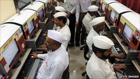 Men using computers in India