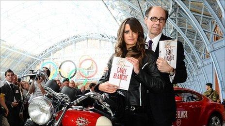 Thriller writer Jeffery Deaver arrives with a Bond girl to promote his new James Bond novel