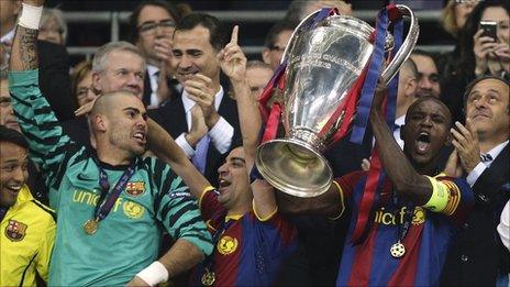 Eric Abidal lifts the cup as Barcelona win the Champions League