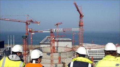 People look at the construction site of the third-generation European Pressurised Water nuclear reactor (EPR) in Flamanville, north-western France, in this file picture taken in April 2011