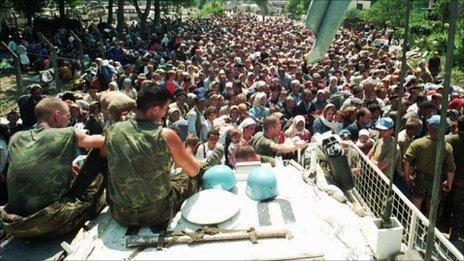 Dutch UN peacekeepers watching Muslim refugee near Srebrenica, on 13 July 1995