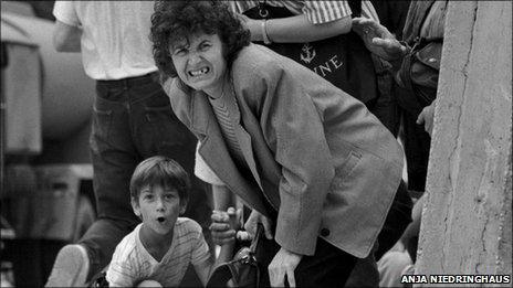 A mother and son attempt to cross a road in Sarajevo