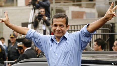 Ollanta Humala makes the victory sign after voting in Peru's presidential election on 5 June 2011