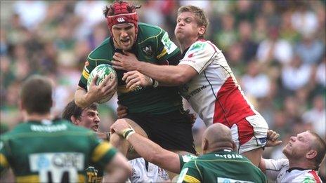 Northampton's Christian Day is tackled by Chris Henry of Ulster in last season's Heineken Cup quarter-finals
